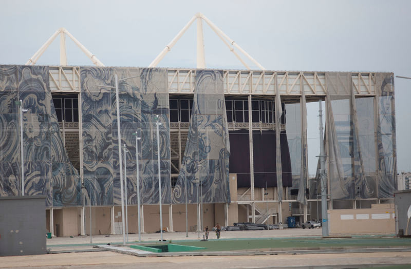 Tapestries created by local artist Adriano Varejão hang in tatters outside of the Olympic Aquatic stadium (Image: AP)